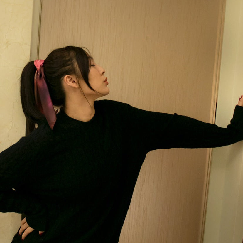 beautiful model wearing a french colorful silk twill scarf as a hair tie